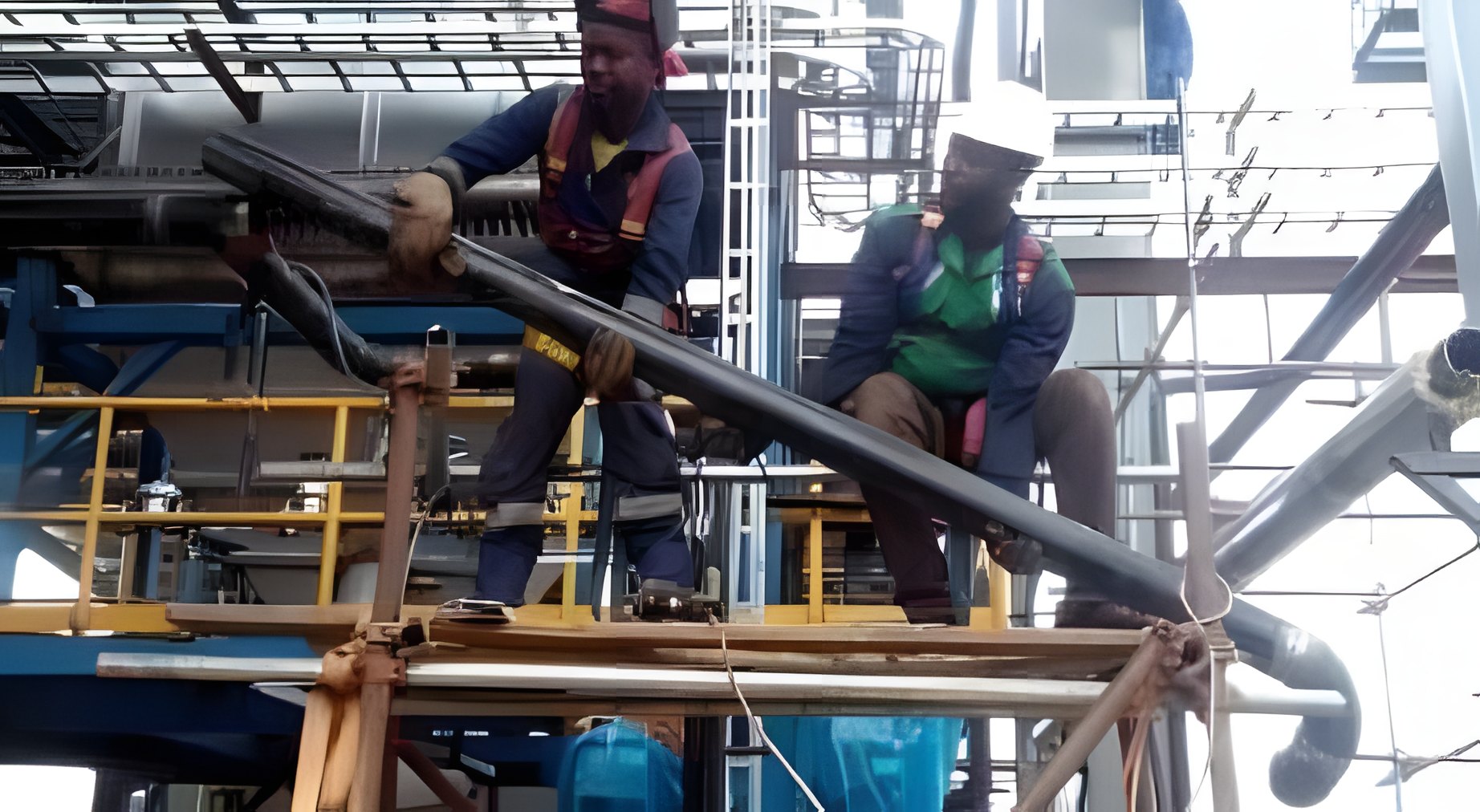 Workers preparing a pipe header on site as part of plant shutdown work