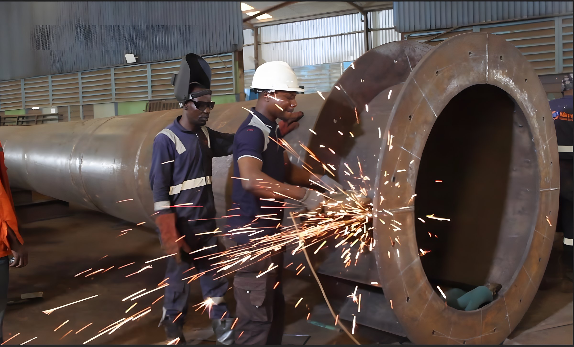 Sparks fly during structural steel fabrication in the Maven workshop in Lagos